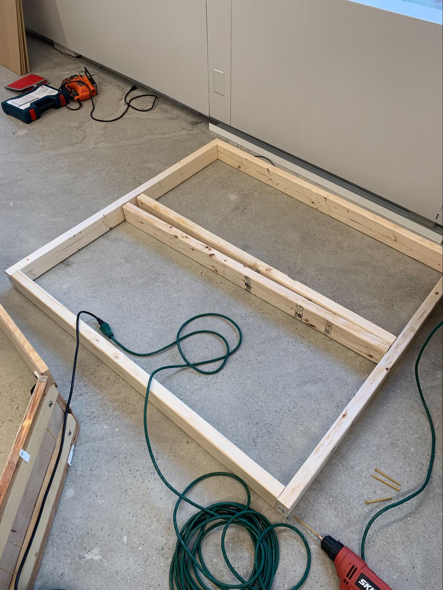 4' x 4' square made with wood pieces on the floor.